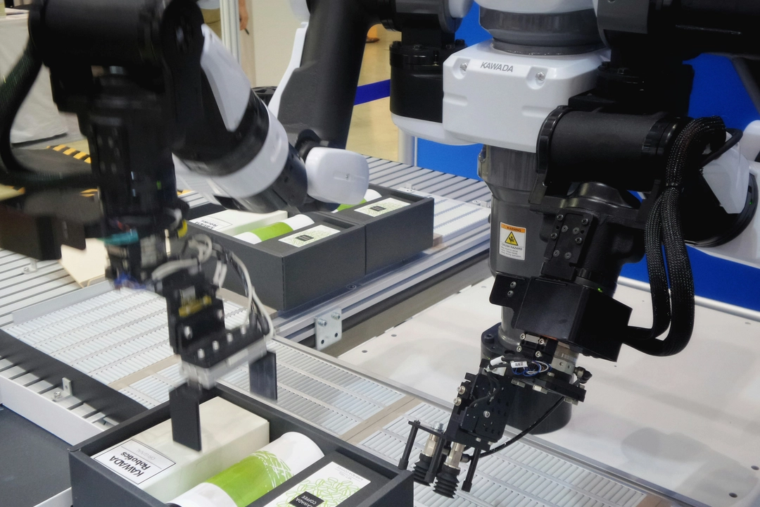 Industrial robotic arms utilizing advanced programming techniques on a production line, highlighting precision and efficiency in manufacturing settings, relevant to discussions on the best Python serialization modules for data handling in automation.