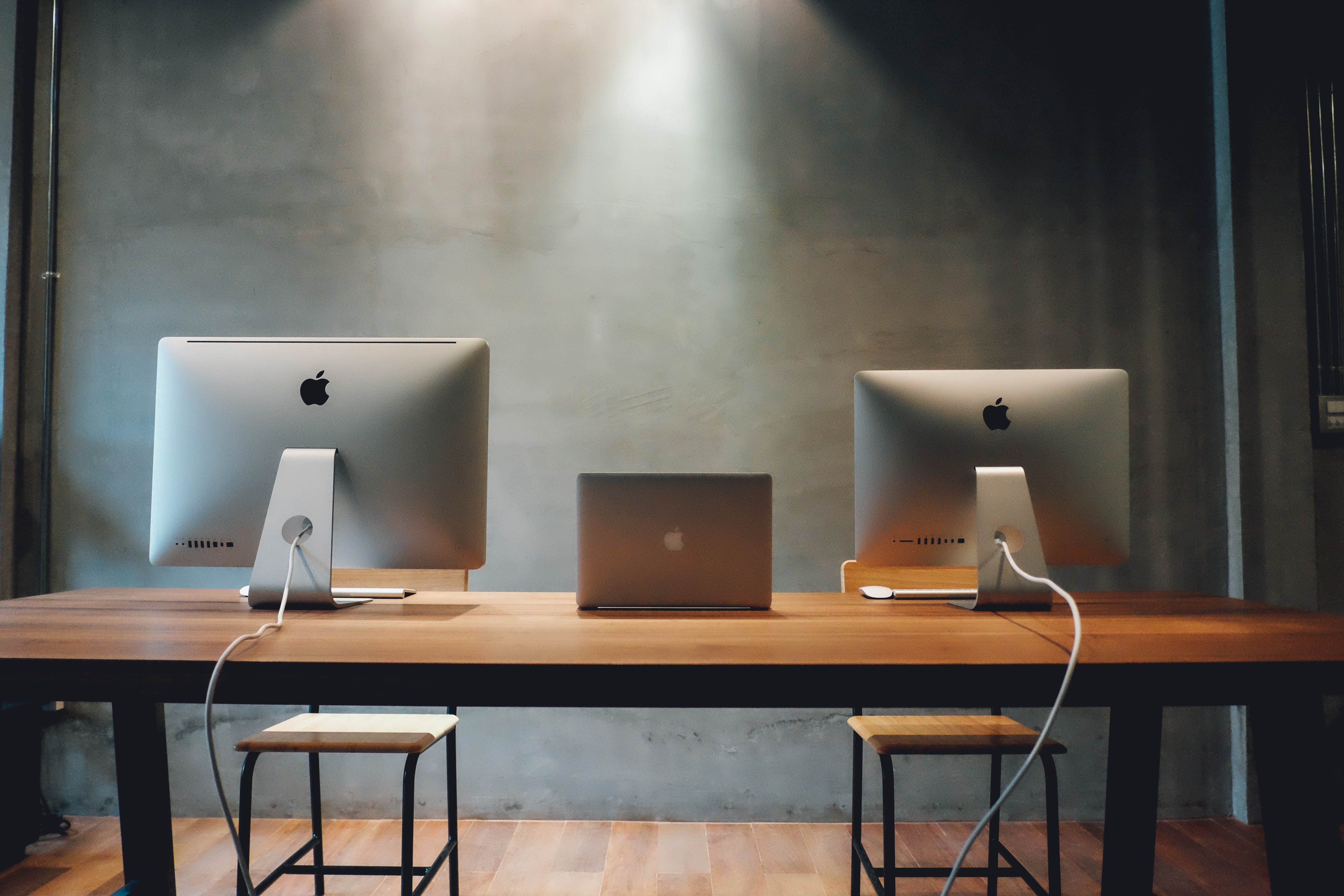 Contemporary coding workspace featuring Apple iMac and MacBook, exemplifying an environment where best practices for class design in object-oriented programming are applied.